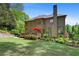 Large home featuring a wooden deck and lush landscaped backyard at 5725 Lake Oak Lndg, Cumming, GA 30040