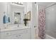 Bright bathroom featuring a vanity with sink, mirror and floral shower curtain at 5725 Lake Oak Lndg, Cumming, GA 30040