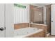 Bathroom featuring a soaking tub with a shower at 5725 Lake Oak Lndg, Cumming, GA 30040