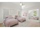 Bright bedroom featuring two twin beds, decor, and a comfortable lounge area at 5725 Lake Oak Lndg, Cumming, GA 30040