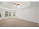 Spacious bedroom with a tray ceiling and large windows at 5725 Lake Oak Lndg, Cumming, GA 30040