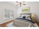 Bright bedroom with natural light, neutral color palette, ceiling fan, and a view of the backyard at 5725 Lake Oak Lndg, Cumming, GA 30040