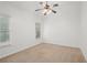 Simple bedroom with neutral carpet, white walls, and a ceiling fan at 5725 Lake Oak Lndg, Cumming, GA 30040