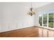 Bright dining room featuring hardwood floors, large window, and chandelier at 5725 Lake Oak Lndg, Cumming, GA 30040