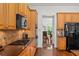 Well-equipped kitchen with stainless steel appliances and wood cabinets at 5725 Lake Oak Lndg, Cumming, GA 30040