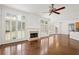 Bright living room featuring hardwood floors, fireplace, and large windows at 5725 Lake Oak Lndg, Cumming, GA 30040
