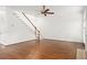 Bright living room features a staircase and hardwood floors at 5725 Lake Oak Lndg, Cumming, GA 30040