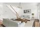Bright living room features a staircase, neutral furniture, hardwood floors, and modern lighting at 5725 Lake Oak Lndg, Cumming, GA 30040