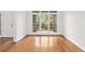 Bright living room featuring hardwood floors and a wall of windows at 5725 Lake Oak Lndg, Cumming, GA 30040