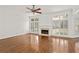 Bright living room featuring hardwood floors, fireplace, and large windows at 5725 Lake Oak Lndg, Cumming, GA 30040