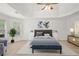 Staged primary bedroom boasts tray ceilings, ample natural light, and neutral finishes at 5725 Lake Oak Lndg, Cumming, GA 30040