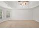Spacious bedroom featuring a tray ceiling, neutral walls, and comfortable carpet flooring at 5725 Lake Oak Lndg, Cumming, GA 30040