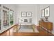 Well-lit home office features hardwood floors, stylish desk and large windows at 5725 Lake Oak Lndg, Cumming, GA 30040