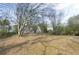 A view of the home's spacious backyard, highlighting the natural surroundings and landscaping at 6057 Dorchester Dr, Rex, GA 30273