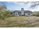 A view of the home's backyard featuring a grassy lawn, patio area and the rear exterior of the house at 6057 Dorchester Dr, Rex, GA 30273