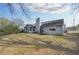 The home's backyard features a grassy lawn and partial view of the home's rear exterior and patio at 6057 Dorchester Dr, Rex, GA 30273