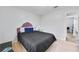Bedroom with wood floor, a tufted headboard bed, and a light blue wall at 6057 Dorchester Dr, Rex, GA 30273