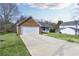Exterior side view of home and long driveway leading to the attached two car garage at 6057 Dorchester Dr, Rex, GA 30273