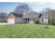 Street view of charming home showcasing the lush front lawn and covered front porch at 6057 Dorchester Dr, Rex, GA 30273