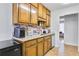 Galley kitchen features wood cabinets, granite countertops, and stainless steel appliances at 6057 Dorchester Dr, Rex, GA 30273