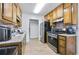 Kitchen with wooden cabinets and stainless steel oven and refrigerator at 6057 Dorchester Dr, Rex, GA 30273
