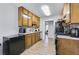 Galley kitchen features wood cabinets, granite countertops, and stainless steel appliances at 6057 Dorchester Dr, Rex, GA 30273