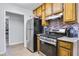 Kitchen with wooden cabinets and stainless steel oven and refrigerator at 6057 Dorchester Dr, Rex, GA 30273