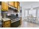 Kitchen and dining area features stainless steel appliances and breakfast table at 6057 Dorchester Dr, Rex, GA 30273