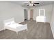 Bedroom featuring a ceiling fan, neutral carpet, walk-in closet, and white trim at 1371 Blazing Star Rd, Lawrenceville, GA 30045