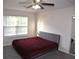 Bedroom featuring a window with blinds, gray carpet, and a ceiling fan at 1371 Blazing Star Rd, Lawrenceville, GA 30045