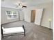 Bright bedroom with large windows, ceiling fan, neutral carpet, and white trim at 1371 Blazing Star Rd, Lawrenceville, GA 30045