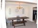 Traditional dining room with chandelier, farmhouse table, and neutral wall décor at 1371 Blazing Star Rd, Lawrenceville, GA 30045