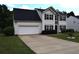Classic two-story home with a two-car garage and traditional landscaping at 1371 Blazing Star Rd, Lawrenceville, GA 30045