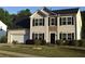 Charming two-story home with a well-manicured lawn and attached two-car garage at 1371 Blazing Star Rd, Lawrenceville, GA 30045