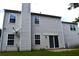Exterior of the two-story home with vinyl siding, windows, and a brick chimney at 1371 Blazing Star Rd, Lawrenceville, GA 30045