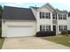 Charming two-story home with a two-car garage and well-maintained lawn and stone accents around front entry at 1371 Blazing Star Rd, Lawrenceville, GA 30045