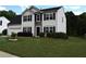 Charming two-story home featuring a well-manicured lawn and an attached two car garage at 1371 Blazing Star Rd, Lawrenceville, GA 30045