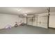 Spacious garage with a two-car garage door, gray painted floor, and an overhead light at 1371 Blazing Star Rd, Lawrenceville, GA 30045