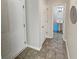Bright hallway featuring neutral paint, tile flooring, and a half bathroom at 1371 Blazing Star Rd, Lawrenceville, GA 30045