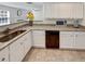 Bright kitchen featuring granite countertops, white cabinetry, and stainless steel appliances at 1371 Blazing Star Rd, Lawrenceville, GA 30045