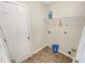 Laundry room featuring vinyl floors, white walls, and a shelf at 1371 Blazing Star Rd, Lawrenceville, GA 30045