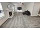 Comfortable living room with a fireplace, large windows, and neutral carpet at 1371 Blazing Star Rd, Lawrenceville, GA 30045
