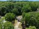 A high aerial view of the home and surrounding trees in a wooded neighborhood at 2442 Falcon Ct, Lawrenceville, GA 30043