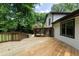 A large backyard deck and screened-in porch can be seen from the side of the house at 2442 Falcon Ct, Lawrenceville, GA 30043