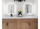 Bathroom featuring dual mirrors, wood vanity, and contemporary fixtures at 2442 Falcon Ct, Lawrenceville, GA 30043