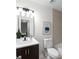 Modern bathroom featuring a white vanity, dark wood cabinets, and updated fixtures at 2442 Falcon Ct, Lawrenceville, GA 30043