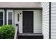 Close-up of the front door with modern house number and outdoor lighting at 2442 Falcon Ct, Lawrenceville, GA 30043