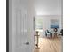 Inviting hallway with light hardwood floors and a glimpse into a tastefully decorated room at 2442 Falcon Ct, Lawrenceville, GA 30043