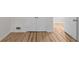 Hallway with hardwood floors, white trim, and a closet for additional storage in the home at 2442 Falcon Ct, Lawrenceville, GA 30043