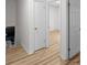 Hallway with hardwood floors and white trim leads to other rooms in the home at 2442 Falcon Ct, Lawrenceville, GA 30043